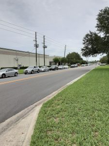 cars lined up to receive a box of food in Orlando, Florida