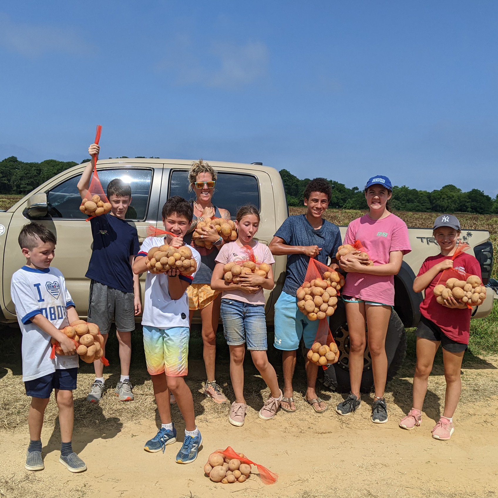 Youth gleaning at a Harvest of Hope Event - July 2022 - Society of St. Andrew